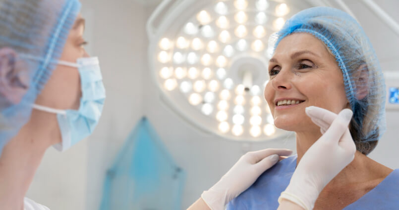 Nurse removing a PICC line from a patient's arm.